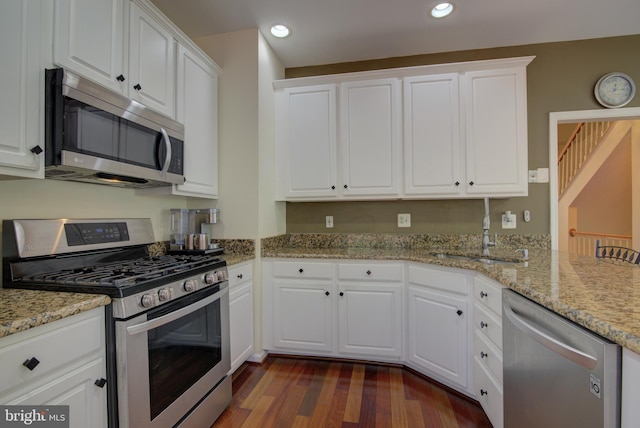 43855 Tattinger Ter, Ashburn, VA 20148 - kitchen featuring stainless steel appliances, dark wood finished floors, white cabinetry, recessed lighting, and light stone counters