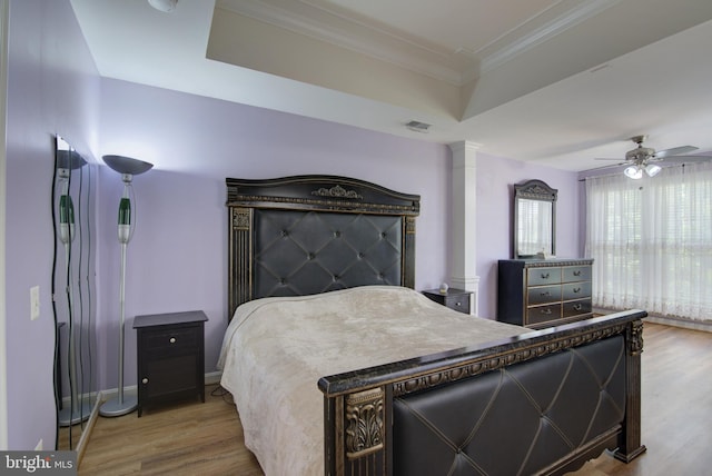 43855 Tattinger Ter, Ashburn, VA 20148 - bedroom featuring wood finished floors, ornate columns, ornamental molding, a ceiling fan, and a tray ceiling