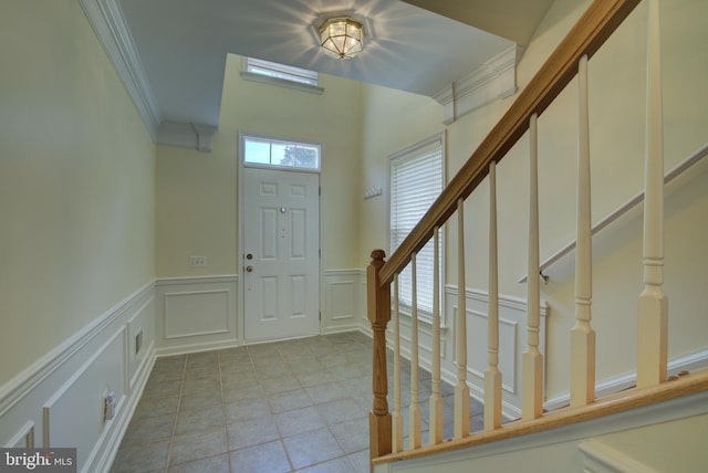 43855 Tattinger Ter, Ashburn, VA 20148 - entryway with a decorative wall, ornamental molding, a wainscoted wall, light tile patterned flooring, and stairway