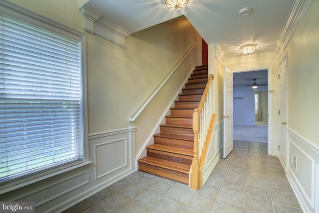 43855 Tattinger Ter, Ashburn, VA 20148 - staircase with a decorative wall, ceiling fan, tile patterned flooring, and a wainscoted wall