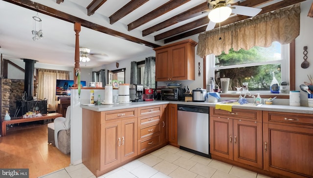 315 Leedom Ave, Bristol, PA 19007 - kitchen featuring dishwasher, a ceiling fan, a wood stove, light countertops, and beam ceiling