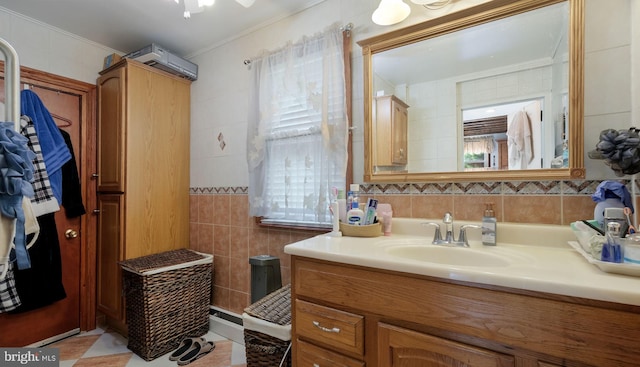 315 Leedom Ave, Bristol, PA 19007 - bathroom with tile walls, vanity, crown molding, and tile patterned floors