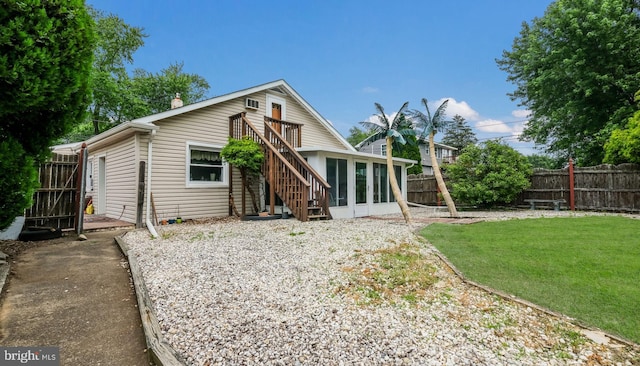 315 Leedom Ave, Bristol, PA 19007 - back of property featuring a fenced backyard, a sunroom, a wooden deck, and stairway