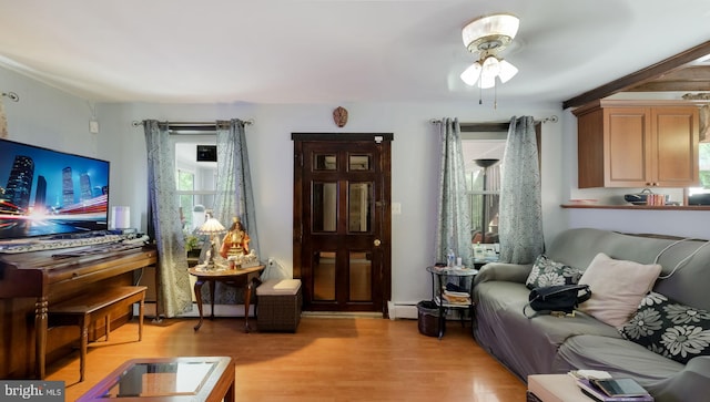 315 Leedom Ave, Bristol, PA 19007 - living area with a baseboard heating unit, light wood-style floors, and a ceiling fan
