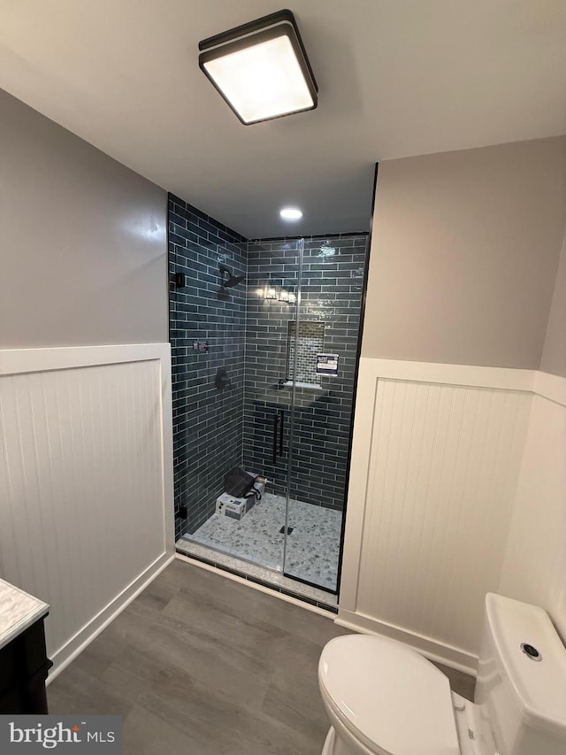 11 Cornwall Rd, Rehoboth Beach, DE 19971 - bathroom featuring a stall shower, wood finished floors, a wainscoted wall, and vanity