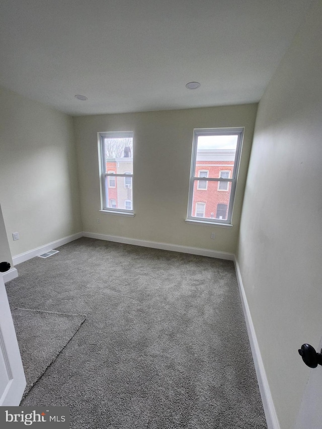 708 N Madeira St, Baltimore, MD 21205 - carpeted empty room with baseboards