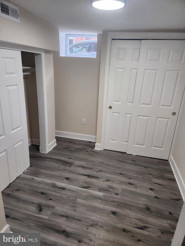 708 N Madeira St, Baltimore, MD 21205 - unfurnished bedroom featuring dark wood finished floors and baseboards