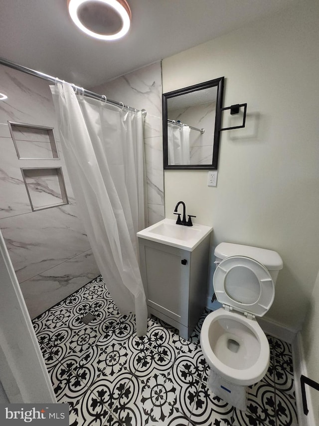708 N Madeira St, Baltimore, MD 21205 - full bath with a shower stall, vanity, and marble finish floors