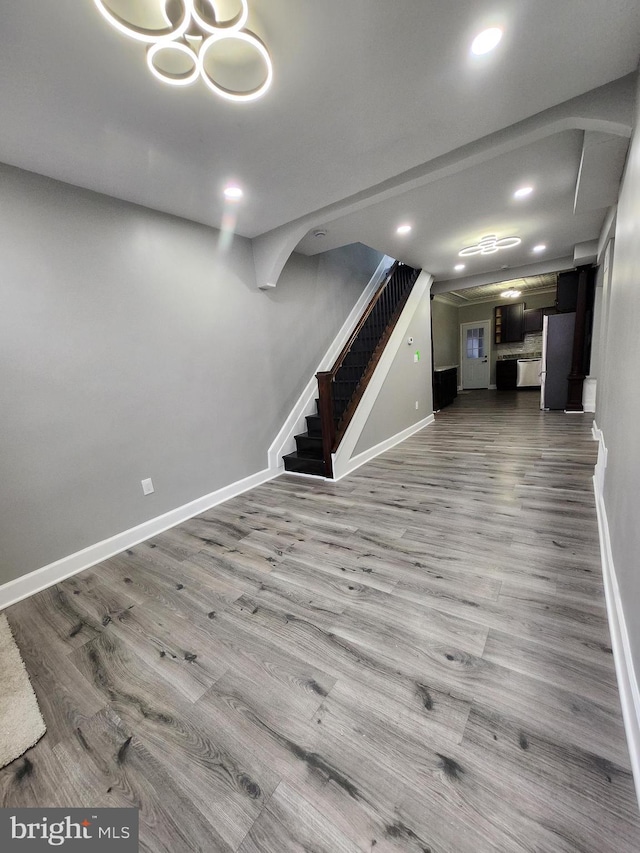 708 N Madeira St, Baltimore, MD 21205 - below grade area featuring stairs, wood finished floors, recessed lighting, and freestanding refrigerator