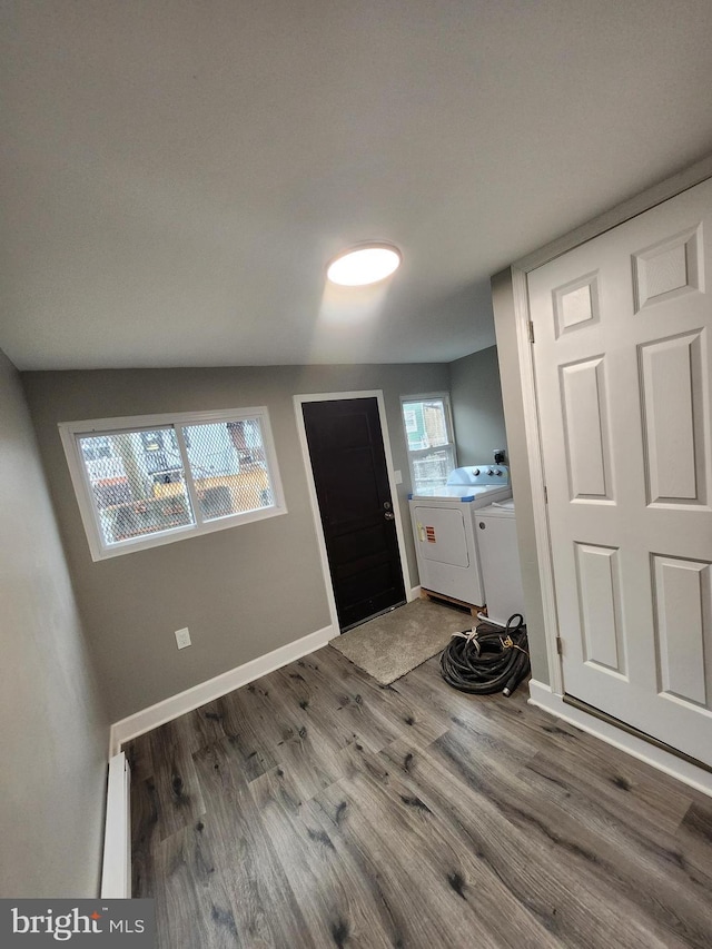 708 N Madeira St, Baltimore, MD 21205 - entryway featuring separate washer and dryer, wood finished floors, and a baseboard radiator