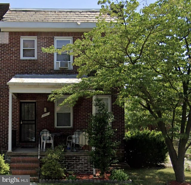 3601 Elmley Ave, Baltimore, MD 21213 - view of front facade with brick siding, cooling unit, and a porch