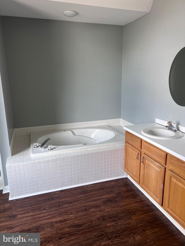 674 Honeysuckle Way, Pennsburg, PA 18073 - bathroom featuring vanity, a whirlpool tub, and wood finished floors