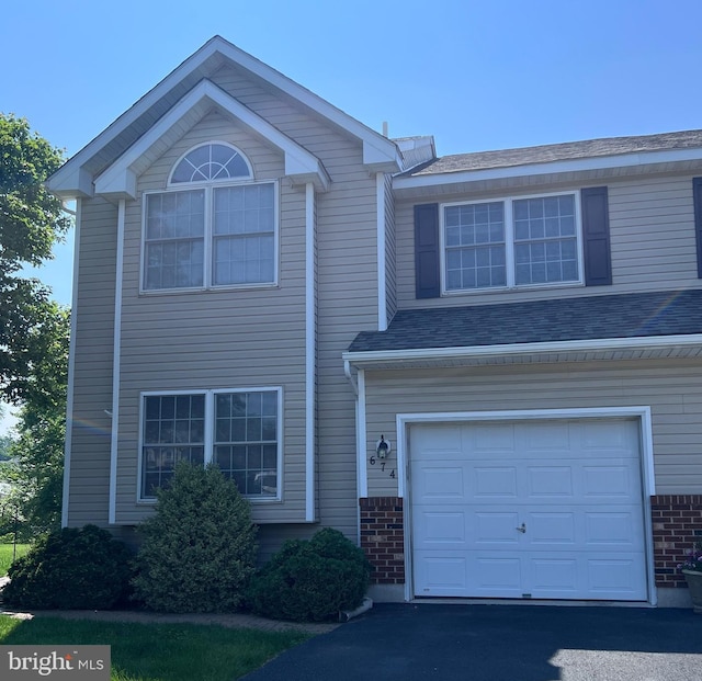 674 Honeysuckle Way, Pennsburg, PA 18073 - view of front of house with an attached garage and brick siding