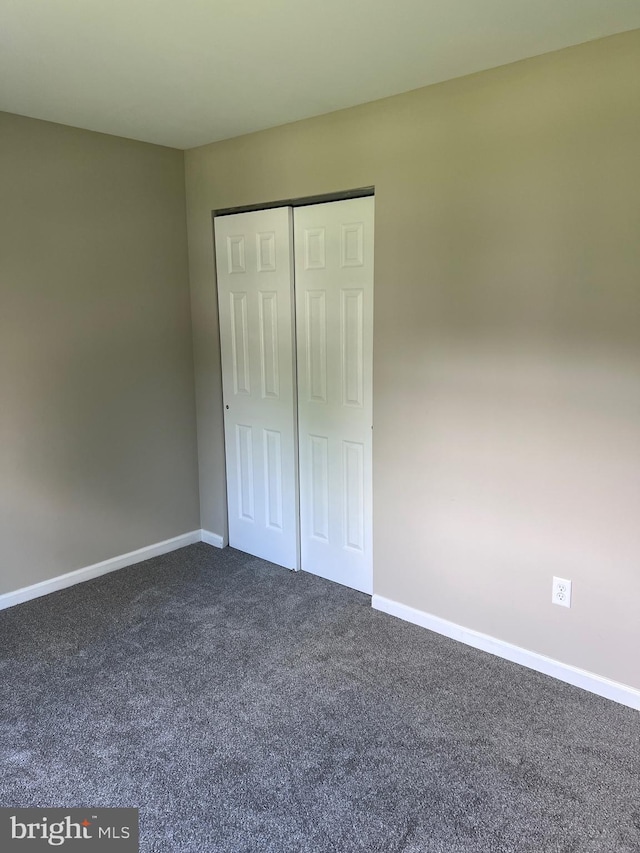 674 Honeysuckle Way, Pennsburg, PA 18073 - unfurnished bedroom with dark colored carpet and a closet