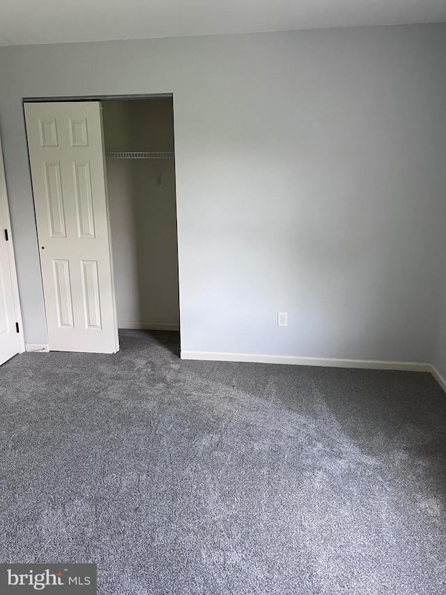 674 Honeysuckle Way, Pennsburg, PA 18073 - unfurnished bedroom featuring dark colored carpet and a closet