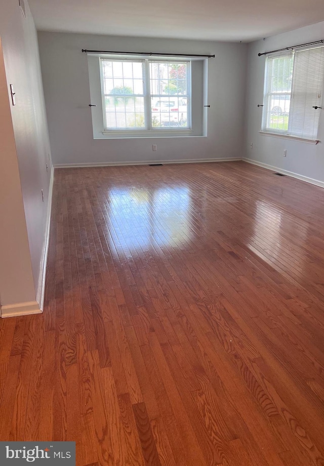674 Honeysuckle Way, Pennsburg, PA 18073 - empty room featuring healthy amount of natural light and wood finished floors