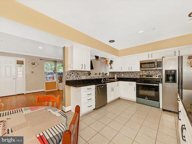 18040 Singing Pine Cir, Montgomery Village, MD 20886 - kitchen with appliances with stainless steel finishes, decorative backsplash, dark countertops, white cabinets, and recessed lighting