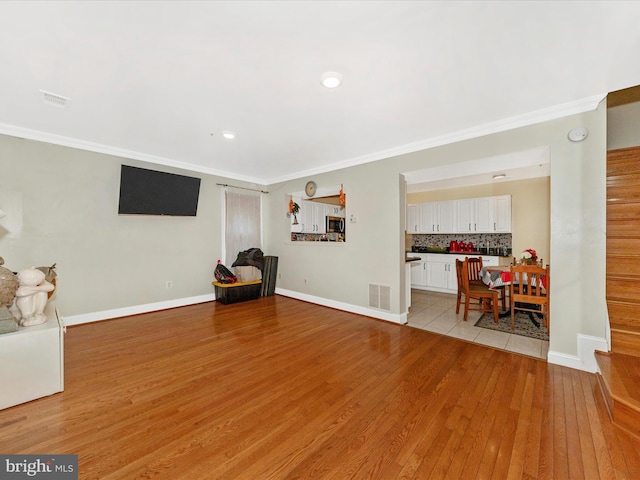18040 Singing Pine Cir, Montgomery Village, MD 20886 - sitting room with light wood finished floors, ornamental molding, and recessed lighting