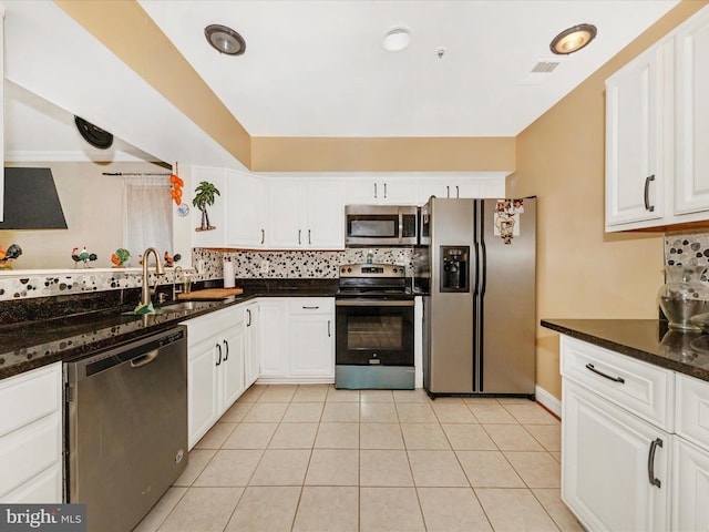 18040 Singing Pine Cir, Montgomery Village, MD 20886 - kitchen with stainless steel appliances, backsplash, white cabinetry, light tile patterned floors, and dark stone counters