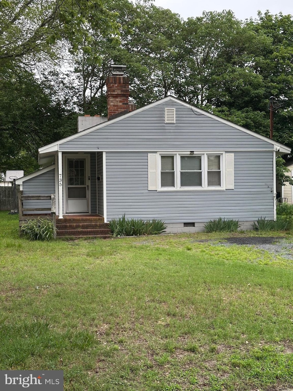 735 Jackson St, Salisbury, MD 21804 - view of front facade with entry steps, a front yard, and a chimney