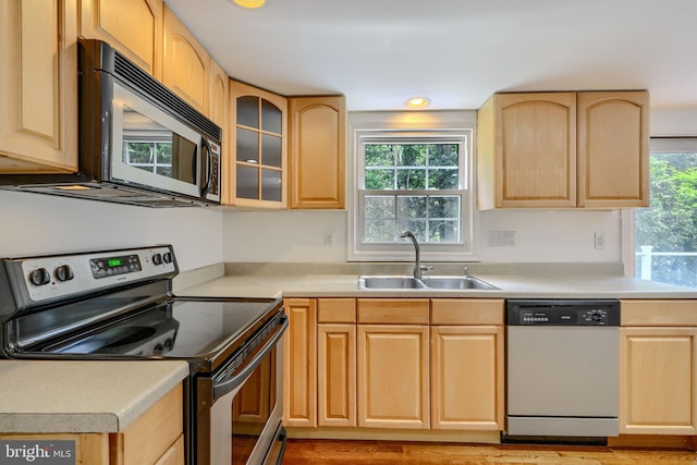 1720 Denton Ct, Crofton, MD 21114 - kitchen featuring stainless steel appliances, light brown cabinetry, light countertops, and glass insert cabinets