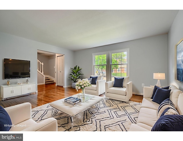 1720 Denton Ct, Crofton, MD 21114 - living area with stairway, wood finished floors, and a baseboard heating unit