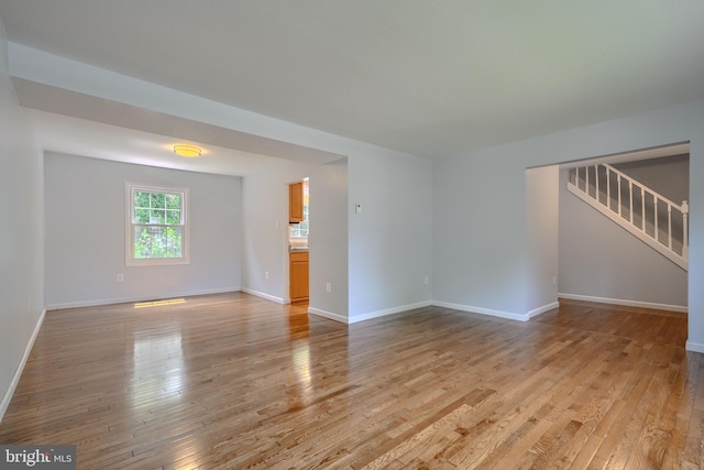 1720 Denton Ct, Crofton, MD 21114 - unfurnished living room with light wood-style flooring and stairs