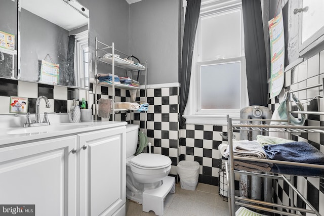 4029 Creston St, Philadelphia, PA 19135 - bathroom with tile walls, vanity, and a wainscoted wall