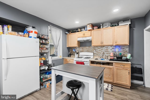 4029 Creston St, Philadelphia, PA 19135 - kitchen with white appliances, under cabinet range hood, light brown cabinetry, backsplash, and recessed lighting