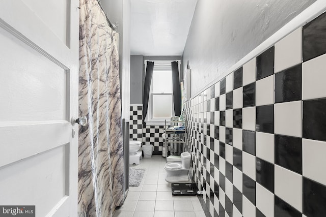 4029 Creston St, Philadelphia, PA 19135 - bathroom with tile walls, tile patterned floors, a bidet, and wainscoting