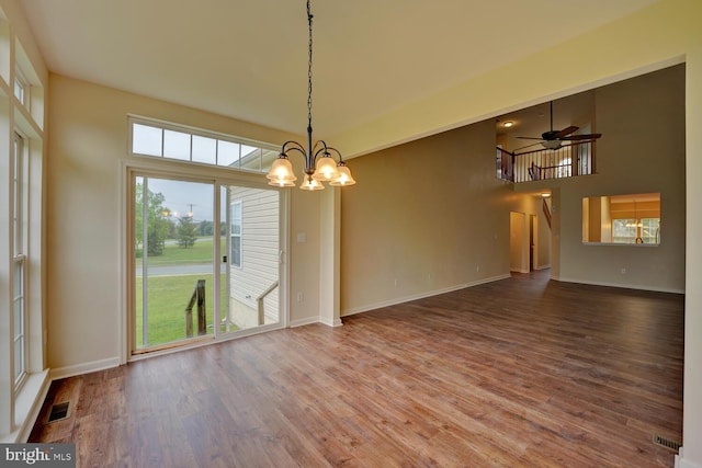 2 N Cummings Dr, Middletown, DE 19709 - empty room with wood finished floors, a chandelier, stairs, and a ceiling fan