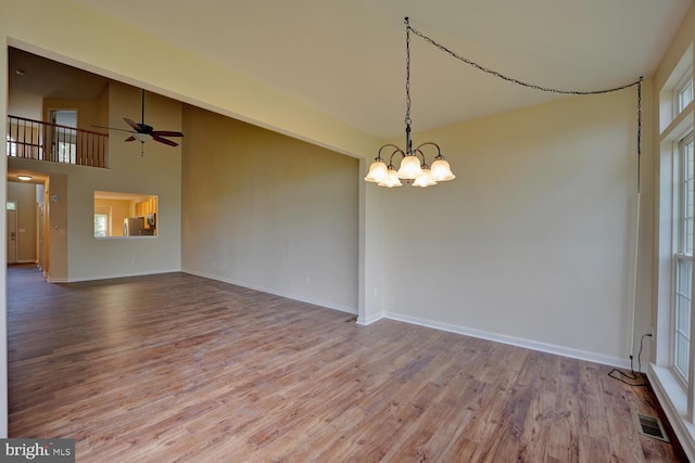 2 N Cummings Dr, Middletown, DE 19709 - unfurnished room featuring a chandelier, wood finished floors, plenty of natural light, a ceiling fan, and a towering ceiling