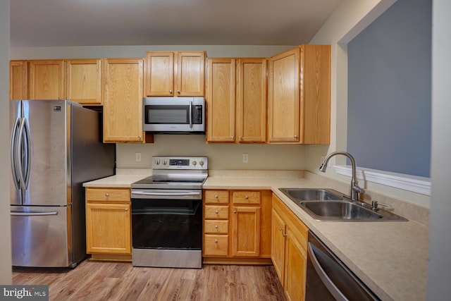 2 N Cummings Dr, Middletown, DE 19709 - kitchen with stainless steel appliances, light wood-type flooring, light countertops, and light brown cabinetry