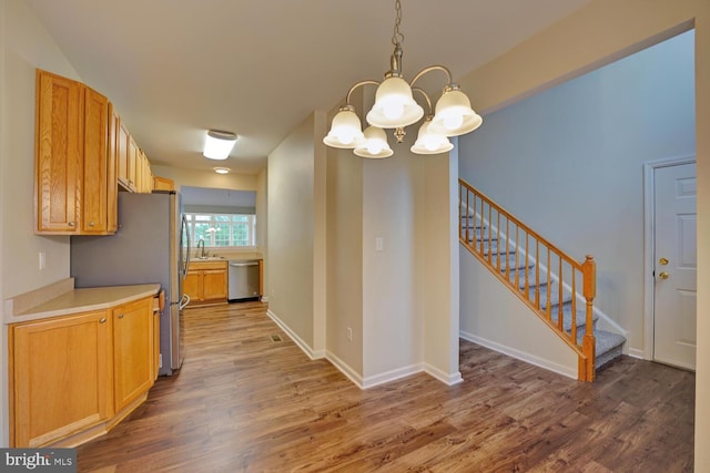 2 N Cummings Dr, Middletown, DE 19709 - kitchen with stainless steel appliances, wood finished floors, a chandelier, light countertops, and decorative light fixtures