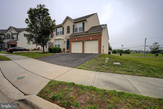 2 N Cummings Dr, Middletown, DE 19709 - view of front of home with driveway, brick siding, a front lawn, and a garage