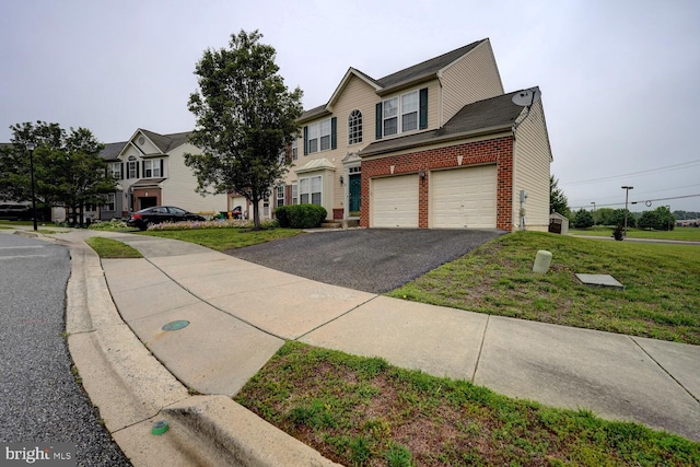 2 N Cummings Dr, Middletown, DE 19709 - view of front of home with brick siding, asphalt driveway, a front lawn, and a residential view