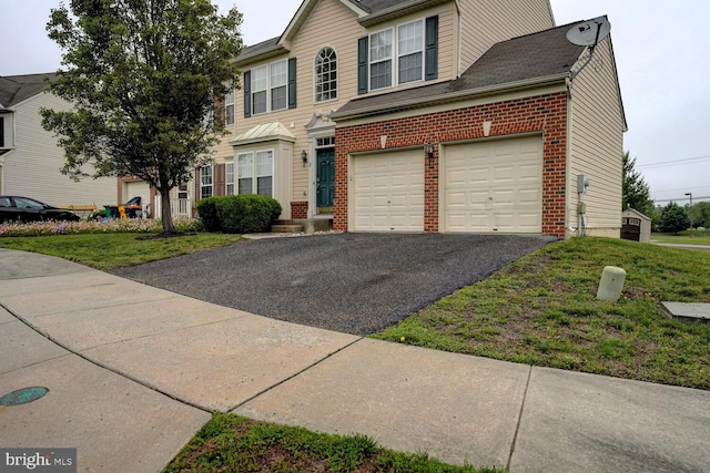 2 N Cummings Dr, Middletown, DE 19709 - view of front facade featuring brick siding, driveway, a front lawn, and a garage
