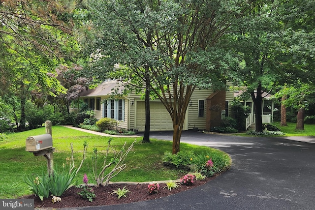 3689 N Carolina Ave, Edgewater, MD 21037 - obstructed view of property with an attached garage, asphalt driveway, and a front lawn