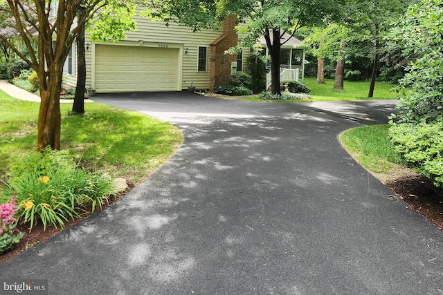 3689 N Carolina Ave, Edgewater, MD 21037 - view of front facade featuring driveway, a garage, and a front lawn