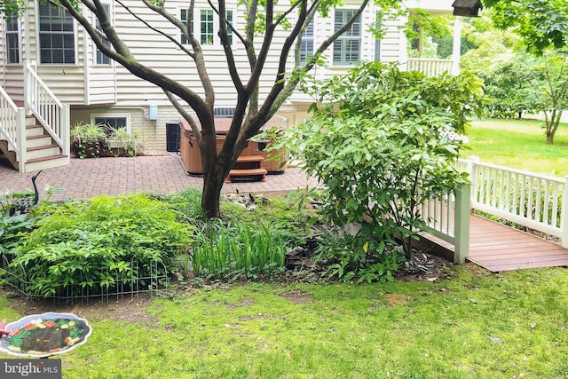 3689 N Carolina Ave, Edgewater, MD 21037 - view of green lawn with stairs, a deck, and a hot tub