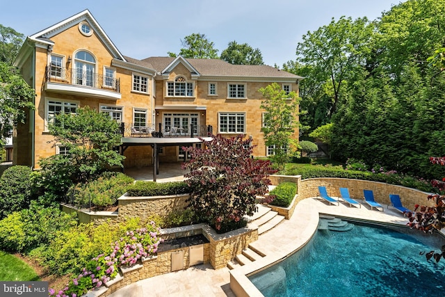 3801 52nd St NW, Washington, DC 20016 - rear view of property with a patio area and an outdoor pool