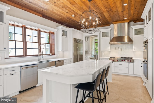 3801 52nd St NW, Washington, DC 20016 - kitchen with stainless steel appliances, wooden ceiling, wall chimney exhaust hood, recessed lighting, and a kitchen island with sink