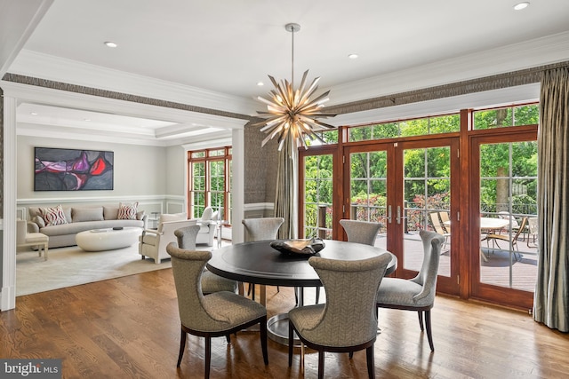 3801 52nd St NW, Washington, DC 20016 - dining room with french doors, a chandelier, a wainscoted wall, ornamental molding, and light wood-style flooring