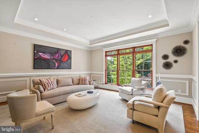3801 52nd St NW, Washington, DC 20016 - living area with a raised ceiling, a decorative wall, crown molding, wood finished floors, and a wainscoted wall