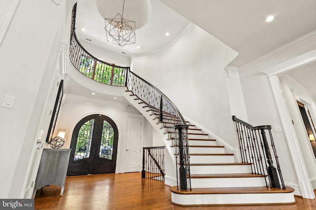 3801 52nd St NW, Washington, DC 20016 - foyer entrance with a high ceiling, french doors, a chandelier, stairway, and wood finished floors