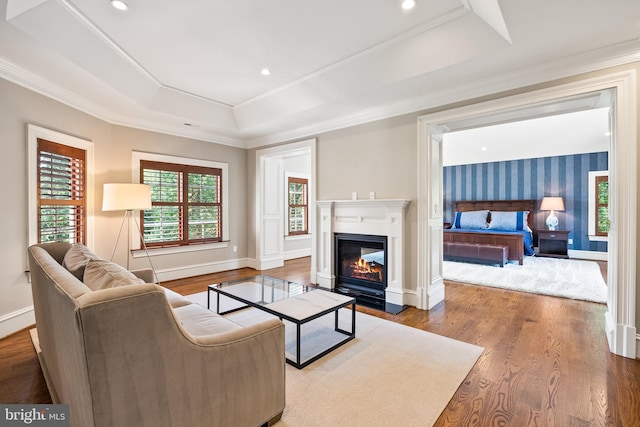3801 52nd St NW, Washington, DC 20016 - living room with a tray ceiling, wood finished floors, a fireplace with flush hearth, ornamental molding, and recessed lighting