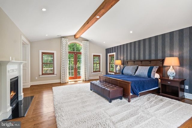3801 52nd St NW, Washington, DC 20016 - bedroom featuring wood finished floors, a glass covered fireplace, wallpapered walls, and recessed lighting