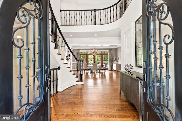 3801 52nd St NW, Washington, DC 20016 - entryway with wood finished floors, ornamental molding, stairway, and a chandelier