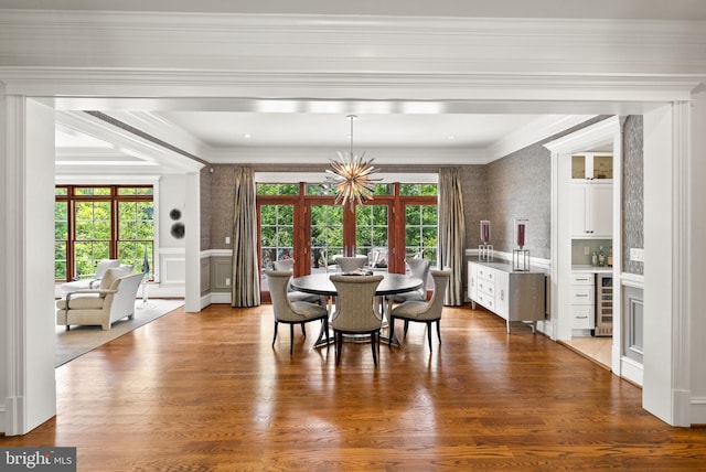 3801 52nd St NW, Washington, DC 20016 - dining space with beverage cooler, wood finished floors, ornamental molding, a dry bar, and a wainscoted wall