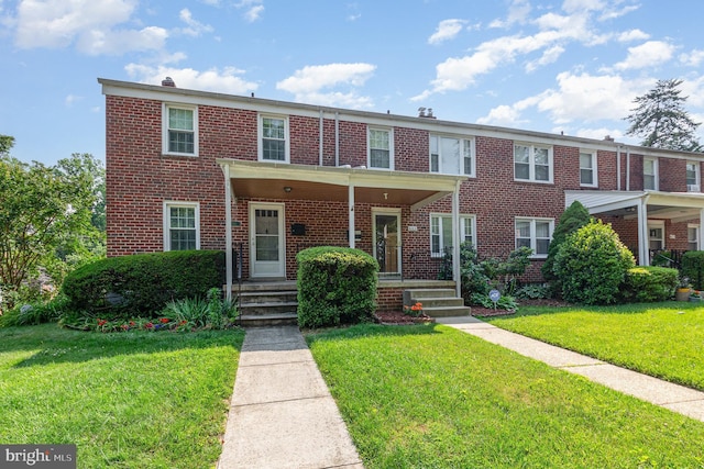 833 Evesham Ave, Baltimore, MD 21212 - view of property with brick siding and a front yard